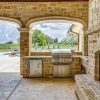 Luxury Home Design by J. Lambert Custom Homes in North Texas - outdoor kitchen and fireplace